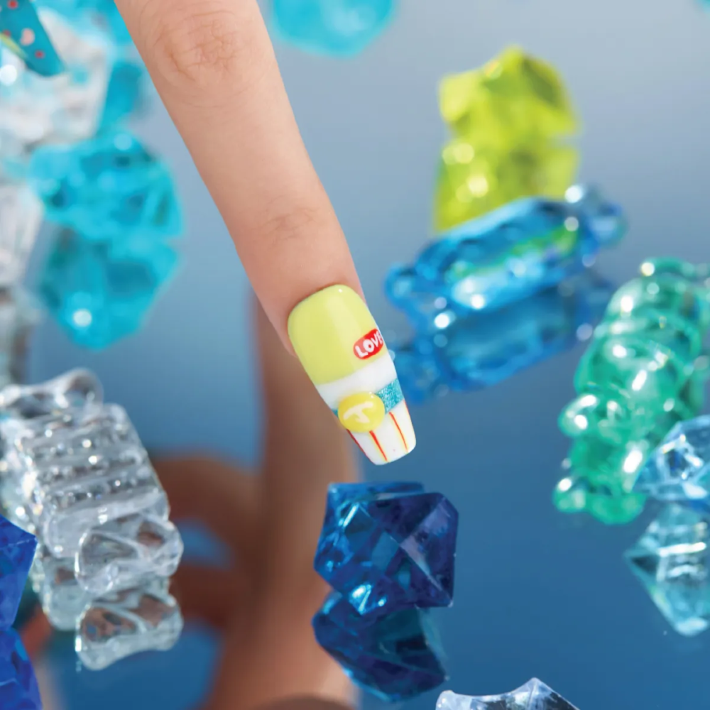 Long coffin press-on nail in lime green and white soda-bottle inspired design with 3D yellow bubble detail.