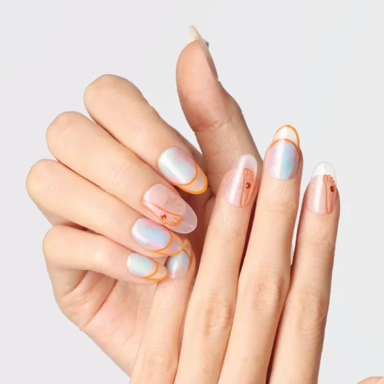 Close-up shot of hands wearing the “Crystal Mist” press-on nails featuring iridescent pastel gradients and orange line-art accents on an almond shape.