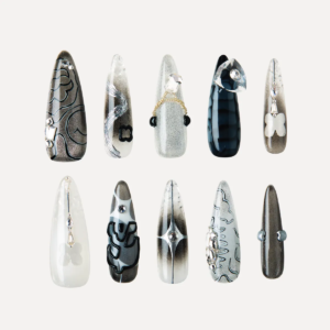Flat lay of Cyber Pulse long stiletto press-on nails arranged in rows with metallic gradients, chrome 3D pieces, and futuristic black-silver designs