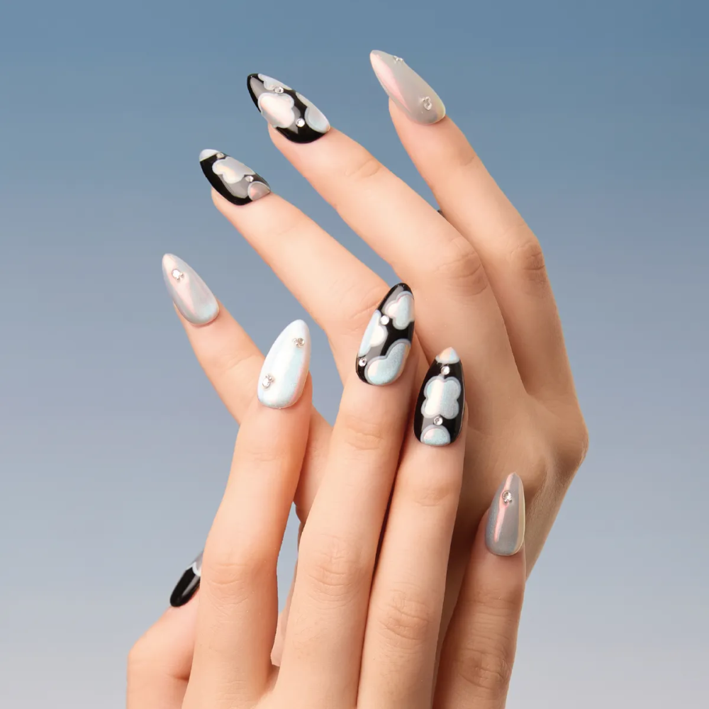 Full hand showcasing LOST in PARK Phantom Bloom nails with silver and pastel cloud accents