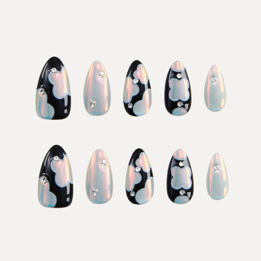 Flat lay of LOST in PARK Phantom Bloom almond-shaped press-on nails in pearl and black patterns