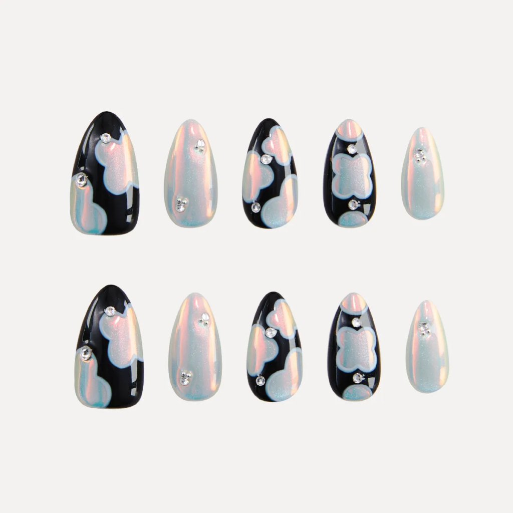 Flat lay of LOST in PARK Phantom Bloom almond-shaped press-on nails in pearl and black patterns