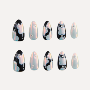 Flat lay of LOST in PARK Phantom Bloom almond-shaped press-on nails in pearl and black patterns