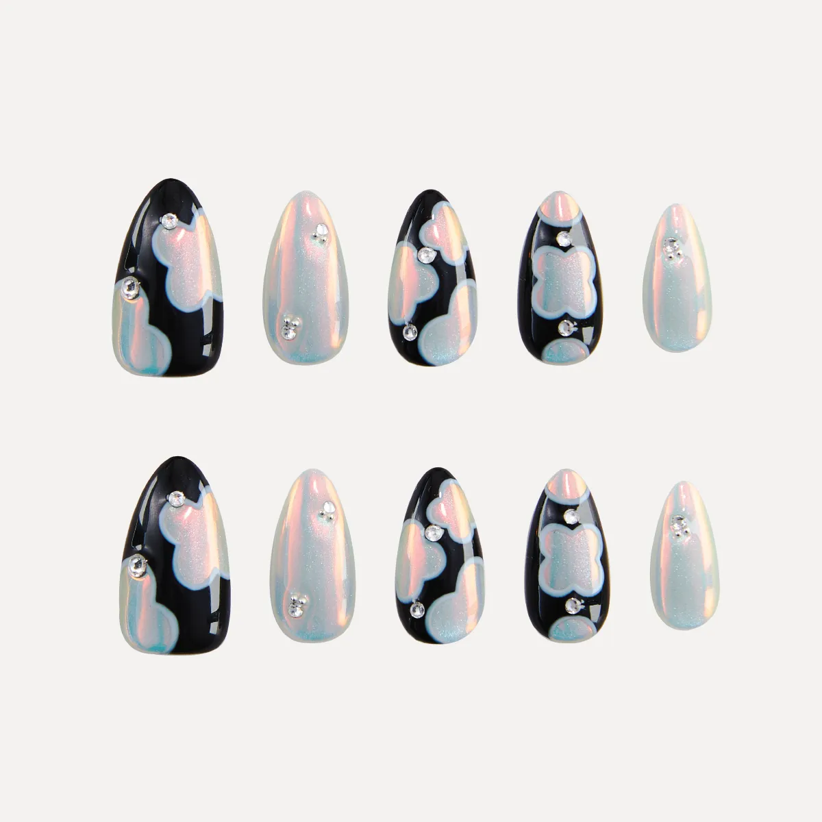 Flat lay of LOST in PARK Phantom Bloom almond-shaped press-on nails in pearl and black patterns