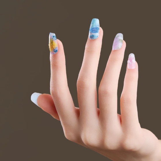 Medium coffin press-on nails with hand pose showing pastel blue and lavender abstract nail art