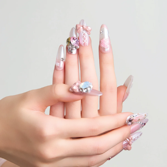 Crystal Ballet press-on nails close-up showing bow, crystal, and soft pink gradient