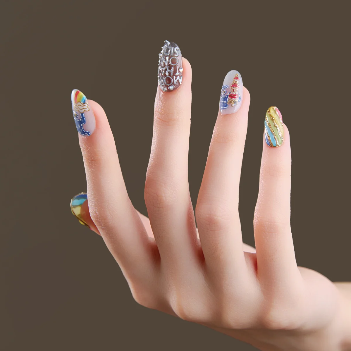 Short oval press-on nails worn on hand with colorful sculptural designs
