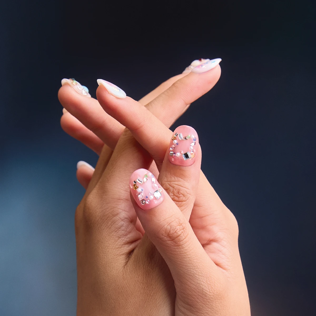 Sweet Charm Box short round press on nails close up with pastel gems and glossy finish