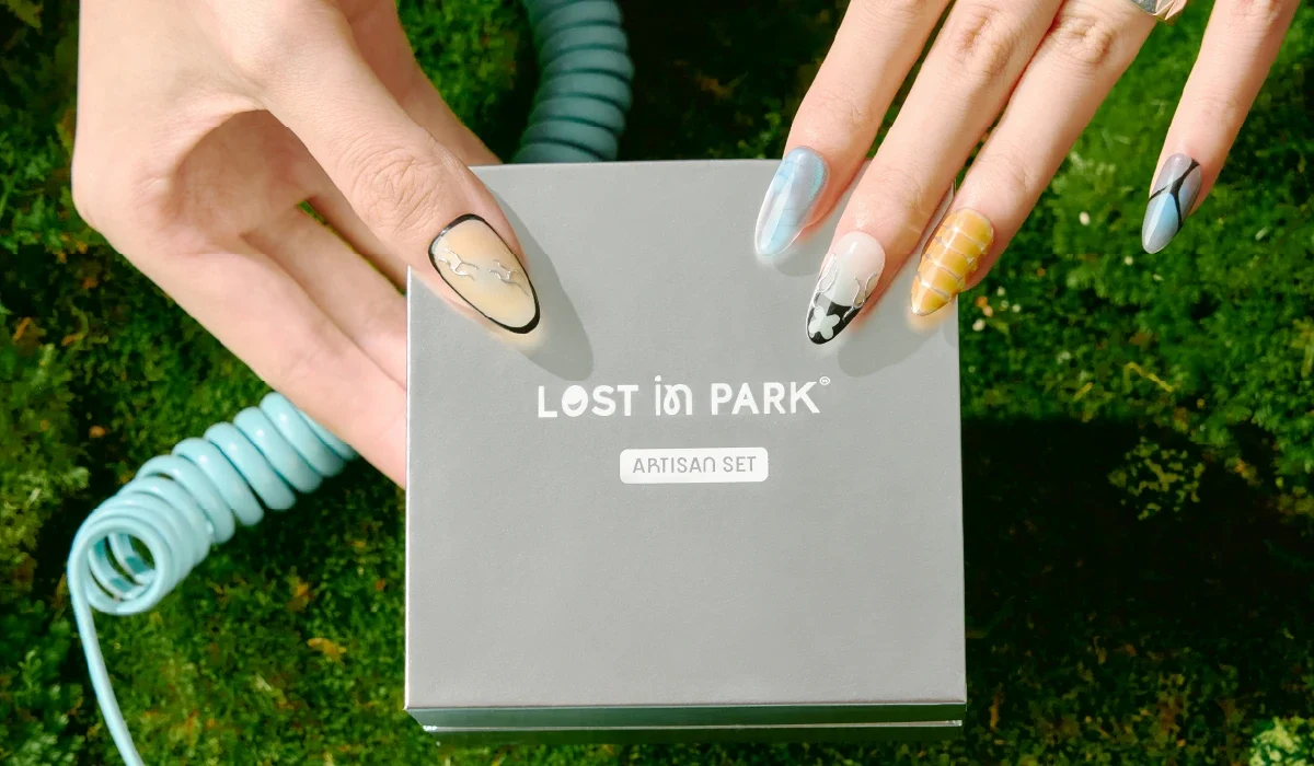 LOST in PARK Artisan Set nail box held by hand with colorful designer press-on nails